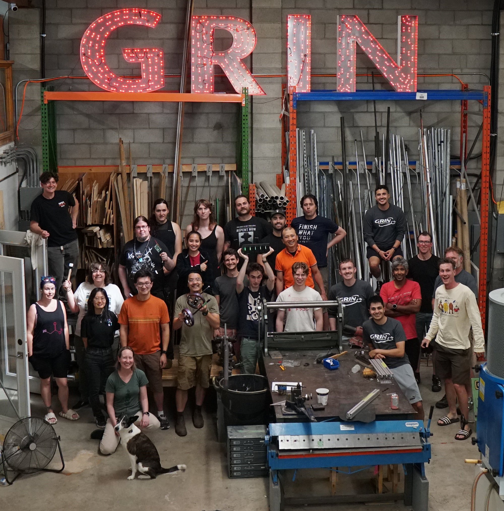 Group of people in a workshop with 'GRIN' sign